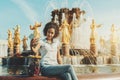 Brazilian teenage girl using cellphone to photograph herself near fountain Royalty Free Stock Photo