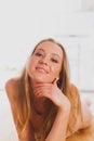 Charming blond woman posing laying on wooden floor Royalty Free Stock Photo