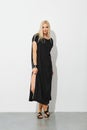 Charming blonde woman in black sleeveless dress