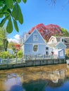 A charming blue house peacefully rests on the riverbank, surrounded by the tranquil waters and serene natural beauty