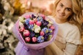 Charming bouquet of colorful spring fresh flowers h in hands of blonde woman.