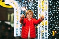 A charming boy holds a sparkler in his hands, celebrating the new year at night on the street. The concept of Christmas Royalty Free Stock Photo
