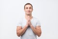 Charming boyfriend, smiling with praying or begging gesture and asking for favour Royalty Free Stock Photo