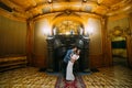 Charming bride and elegant groom at luxurious vintage classic interior have a romantic moment near fireplace Royalty Free Stock Photo