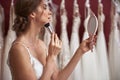 Charming bride in wedding dress doing make-up Royalty Free Stock Photo