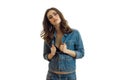 Charming brunette in jeans jacket posing in Studio