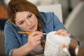 charming brunette woman paints clay cup Royalty Free Stock Photo