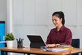 Businesswoman sitting in office and searching information on computer tablet. Royalty Free Stock Photo