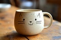 Charming cat-faced mug rests on a rustic wooden table, adding a touch of whimsy to the daily ritual of coffee or tea Royalty Free Stock Photo
