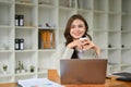 Charming caucasian businesswoman at her desk, holding a coffee cup, looking away Royalty Free Stock Photo