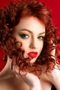 Charming caucasian woman with red hair and bright makeup