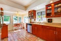 Charming cherry wood kitchen with tile floor. Royalty Free Stock Photo