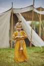 Charming child in embroidered dress at the viking festival in Denmark