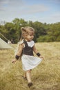 Charming child in primitive clothes at the viking festival in Denmark