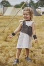 Charming child in primitive clothes at the viking festival in Denmark