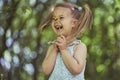 Cute child tearing off flower petals while playing - loves or dislike