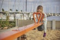 Charming child swings on a playground in Denmark