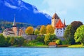 Charming church on lakeside bank of Thun City, on mountain under blue sky background.