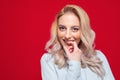 Charming closeup smiling young woman with her fingers on lips. Smile expression face of cute girl, isolated on white background Royalty Free Stock Photo