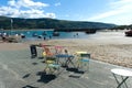 Charming coastal landscape with a beautiful sandy beach at the popular Welsh seaside resort of Barmouth. Cafe with painted chairs Royalty Free Stock Photo