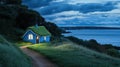 A charming cottage with a grass-covered roof glows warmly at night, nestled on a cliff by the ocean, inviting Royalty Free Stock Photo