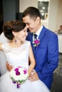 Charming couple bride and groom in the lobby laughing and genuinely smiling positive portrait. Sincere feelings, strong