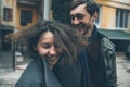 Charming couple in a dress walking down the street