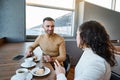 Charming couple in love snacking together in the international airport cafeteria, awaiting customs and passenger control before