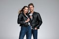 Charming couple posing while she is adjusting her leather jacket Royalty Free Stock Photo