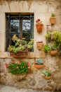 Charming and cozy wall with flower pots on a traditional house in Valldemossa, Mallorca Royalty Free Stock Photo