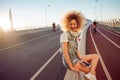 Charming curly blonde music lover. Young woman with big headphones. Royalty Free Stock Photo