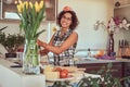 Charming curly Hispanic girl cooking in her kitchen. Royalty Free Stock Photo