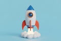Cartoon Rocket Launching with Clouds and Blue Background Royalty Free Stock Photo