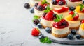A charming display of mini cheesecakes topped with assorted fruit compotes and mint leaves Royalty Free Stock Photo