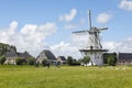 Charming Dutch windmill and horses on pasture