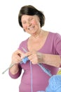 Charming elderly woman knitting large needles. Royalty Free Stock Photo