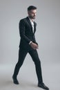 Charming elegant man wearing suit and walking Royalty Free Stock Photo