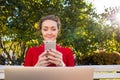 Charming female college student using applications on cell telephone Royalty Free Stock Photo