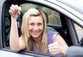 Charming female driver showing a key