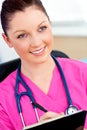 Charming female nurse holding a clipboard