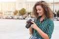 Charming female photographer taking photos during city walk Royalty Free Stock Photo