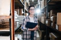 Charming female warehouse distribution worker holding a clipboard Royalty Free Stock Photo