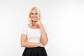 Charming flirtatious girl in a white t-shirt with a layout smiles on a white background isolated studio