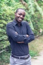 A charming, friendly african man who stands smiling and shows sincere respect Royalty Free Stock Photo