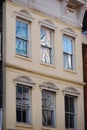 Charming front of building with six windows in historical district of Charleston, South Carolina.