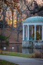 Charming gazebo with a festive Christmas tree with graceful white swans on the pond Royalty Free Stock Photo