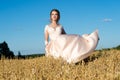 Charming girl in beautiful beige dress in field rye Royalty Free Stock Photo