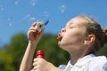 Charming girl blowing soap bubbles Royalty Free Stock Photo