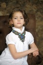 Charming girl child in a white blouse with a beautiful necklace Royalty Free Stock Photo