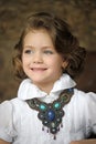 Charming girl child in a white blouse with a beautiful necklace Royalty Free Stock Photo